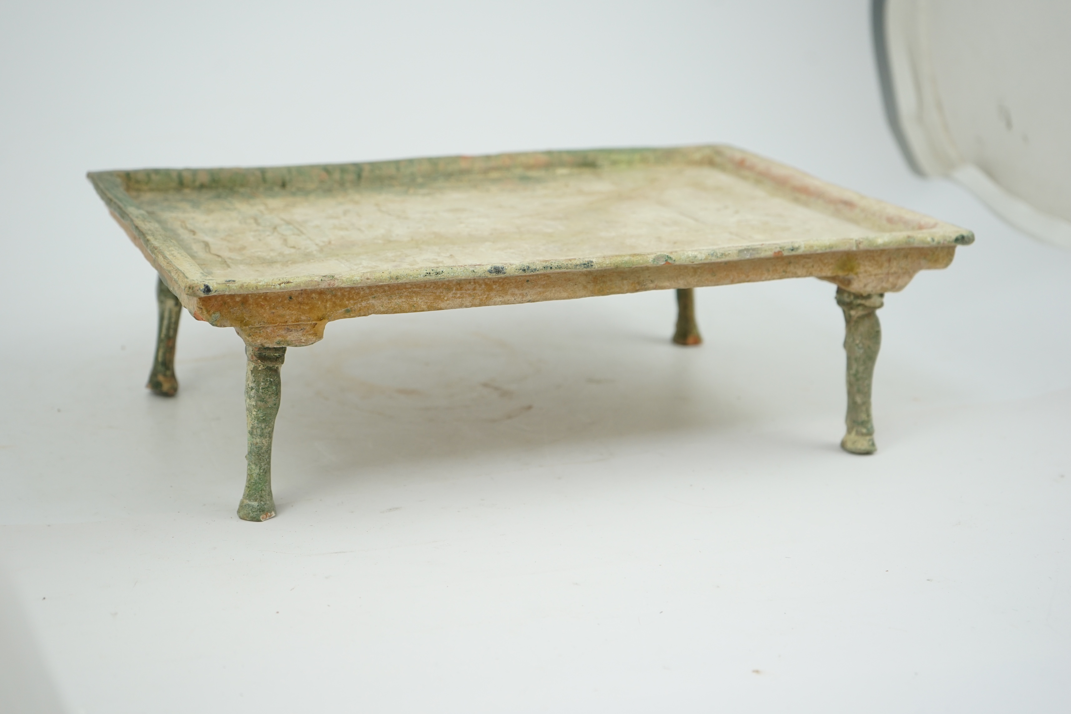 A rare Chinese glazed decorated pottery table with legs, Han Dynasty (206 BC-AD 220).